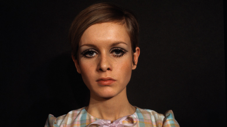 Twiggy posa para una sesión de fotos con un atrevido maquillaje de ojos y una camisa a cuadros