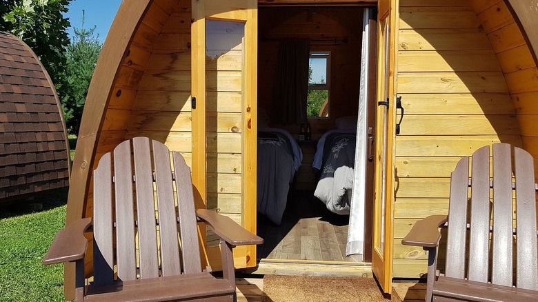 Cabaña glamping con porche y sillas en Long Point Eco-Adventures