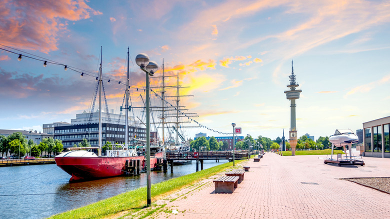 Los grandes barcos están amarrados junto a una pasarela de ladrillos en el soleado paseo marítimo de Bremerhaven, Alemania