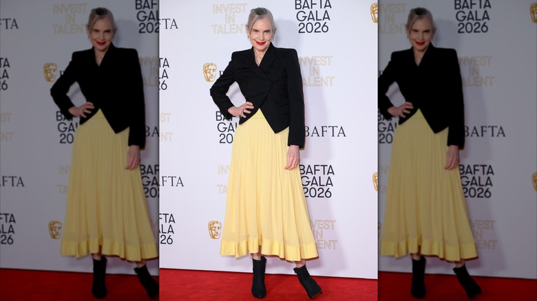 Elizabeth McGovern fotografiada en 2026 con un vestido amarillo pastel y una chaqueta negra