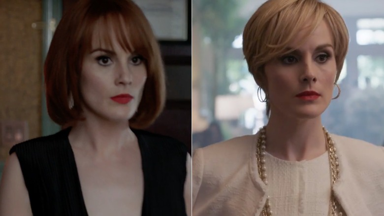 Michelle Dockery como Letty Raines en Good Behavior con un bob rojo, gafas de sol y una camisa negra con cuello en V.